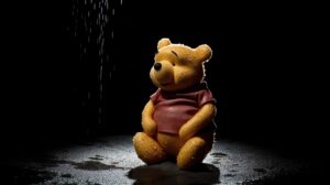 sad winnie the pooh sitting in the darkness