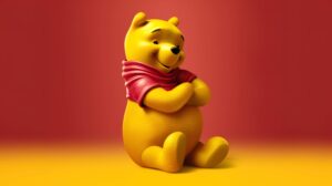 wallpaper of winnie the pooh sitting cross armed with red and yellow background