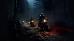 Nighttime dirt bike adventure riders traverse a dark trail illuminated solely by their headlights wallpaper