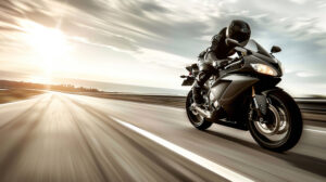 A high speed sports bike zooms along a wide highway leaving a trail of speed and a sense of liberation in its wake