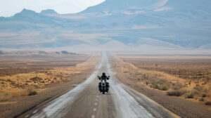 A solo traveler moves peacefully on an abandoned desert highway with the vast openness of the road sprawling ahead in the picture titled Endless Journey