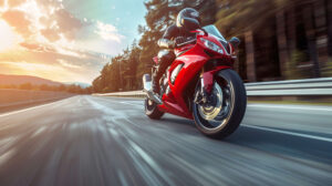 A sports bike speeds down a vast highway exuding a sense of freedom and velocity in its wake captured in a dynamic wallpaper