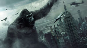 An epic depiction of King Kong scaling the Empire State Building, swatting at airplanes as they circle around him