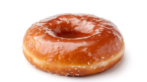 A classic glazed donut featuring a shiny sweet coating showcased against a pristine white backdrop for a strikingly simple and delectable appearance