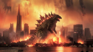 A wallpaper featuring Godzilla roaring against a city skyline with crumbling skyscrapers and flames illuminating the night