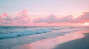A serene beach wallpaper featuring pastel skies at sunset calm waves touching the shore and gentle pink clouds